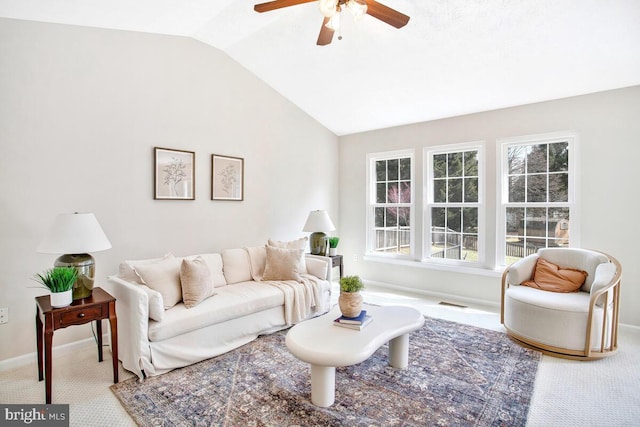 living area featuring vaulted ceiling, carpet flooring, a ceiling fan, and baseboards