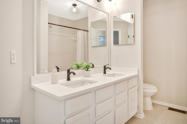 bathroom with a sink, visible vents, baseboards, and toilet