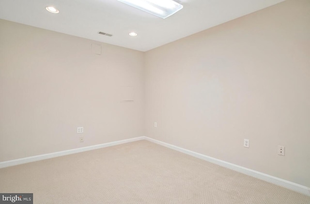 spare room with recessed lighting, visible vents, baseboards, and light colored carpet