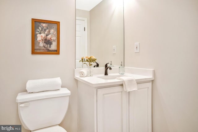 bathroom featuring toilet and vanity