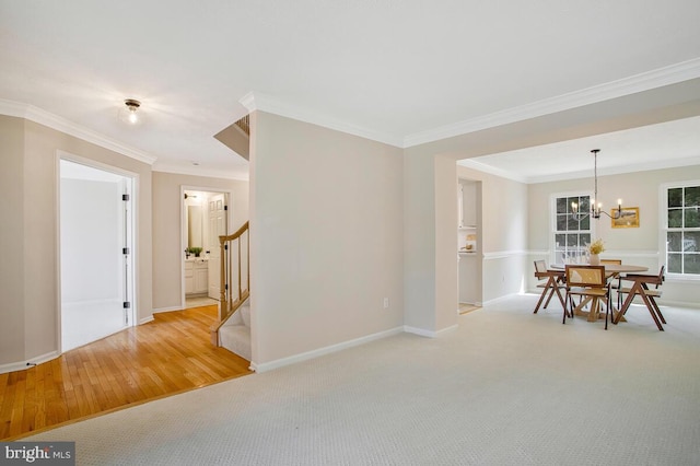 dining area featuring crown molding, baseboards, a chandelier, stairway, and carpet floors