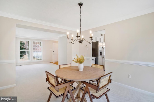 dining area with light colored carpet, crown molding, and baseboards