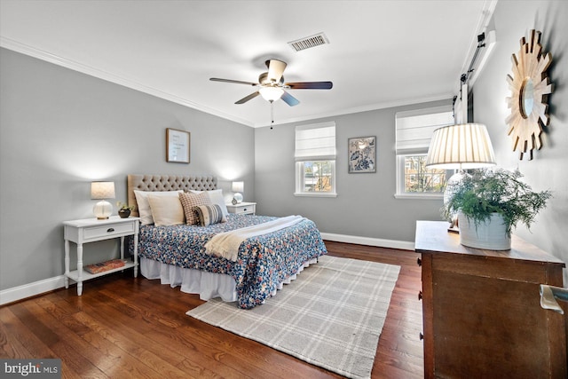 bedroom featuring visible vents, ornamental molding, baseboards, and hardwood / wood-style floors