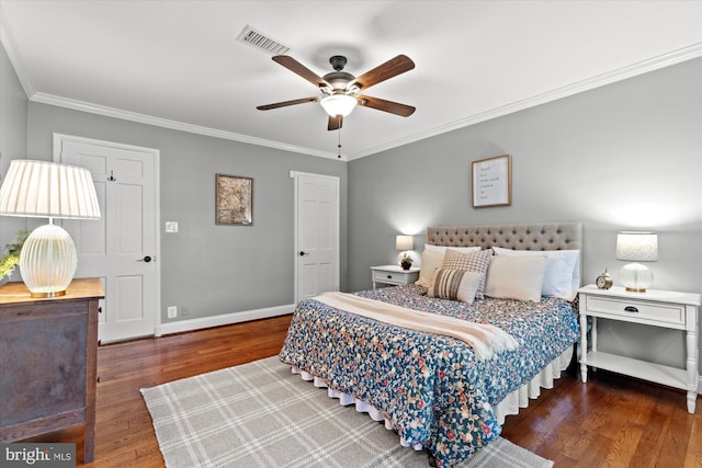 bedroom with visible vents, baseboards, ornamental molding, wood finished floors, and a ceiling fan