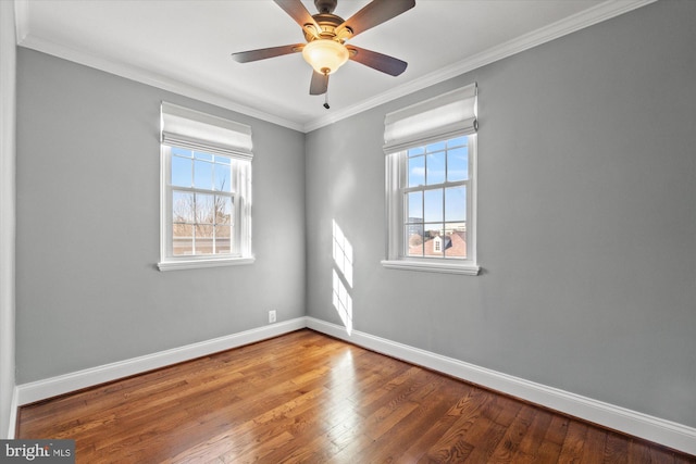 unfurnished room featuring ornamental molding, ceiling fan, baseboards, and wood finished floors