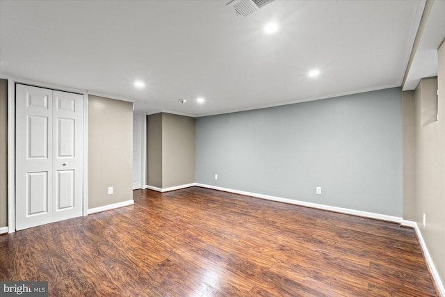 below grade area with visible vents, wood finished floors, recessed lighting, crown molding, and baseboards