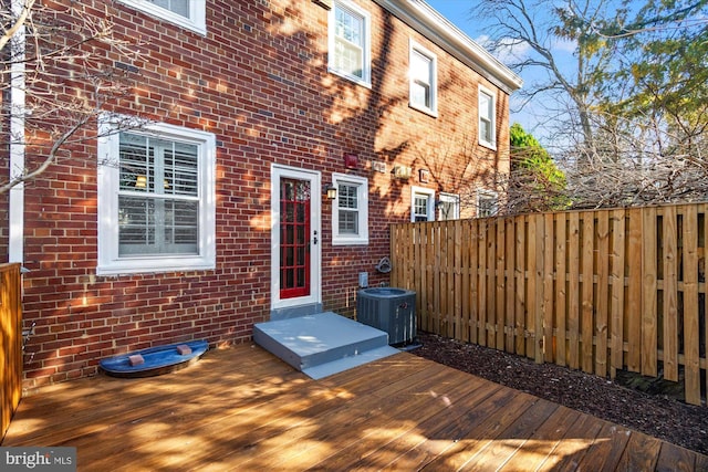 wooden terrace featuring central AC and fence