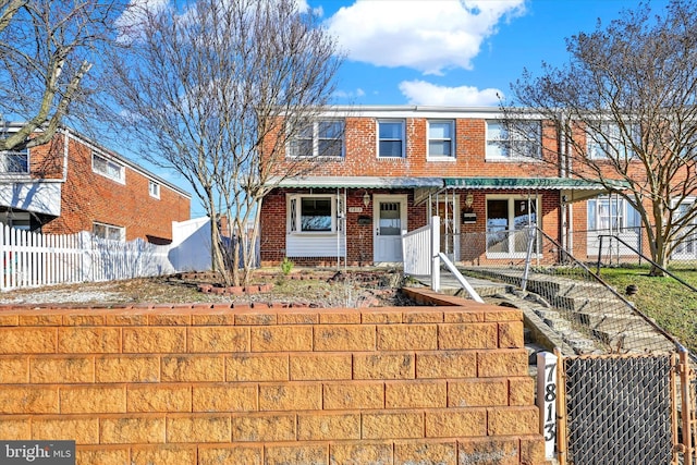 multi unit property featuring brick siding and fence