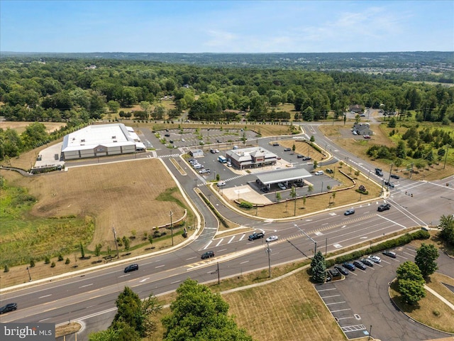 birds eye view of property featuring a view of trees