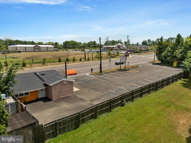 view of home's community with a yard and fence