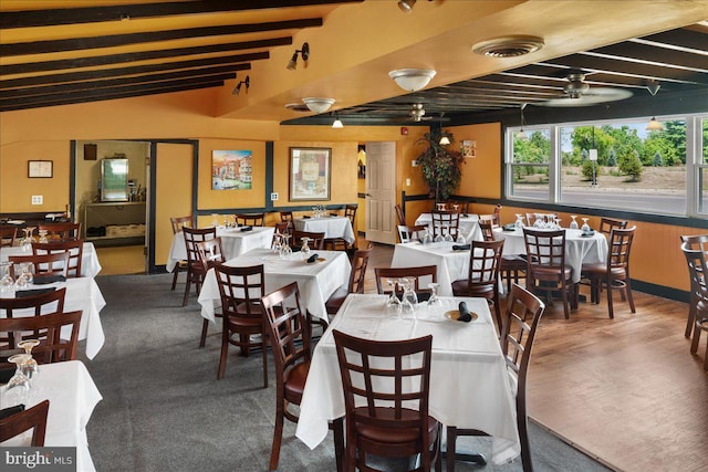 dining space with beamed ceiling, visible vents, and wood finished floors