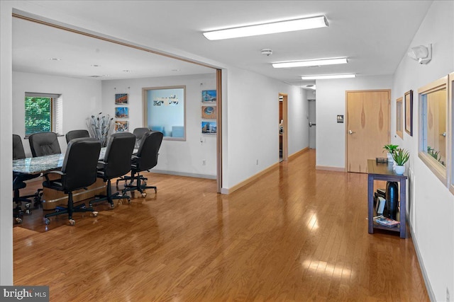 interior space with baseboards and wood finished floors