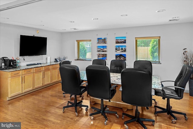 home office with recessed lighting, a healthy amount of sunlight, and light wood-style floors