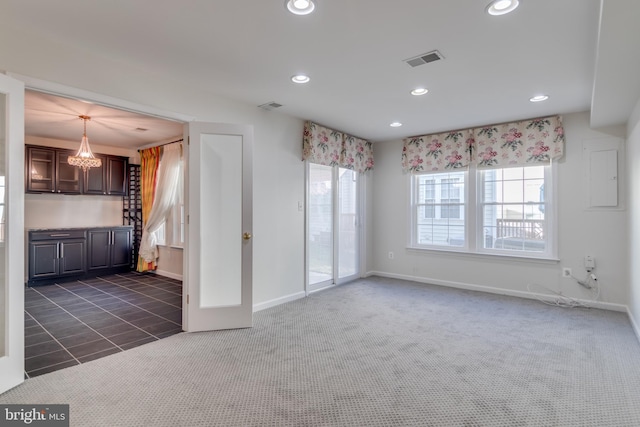 unfurnished living room featuring recessed lighting, visible vents, dark carpet, and baseboards