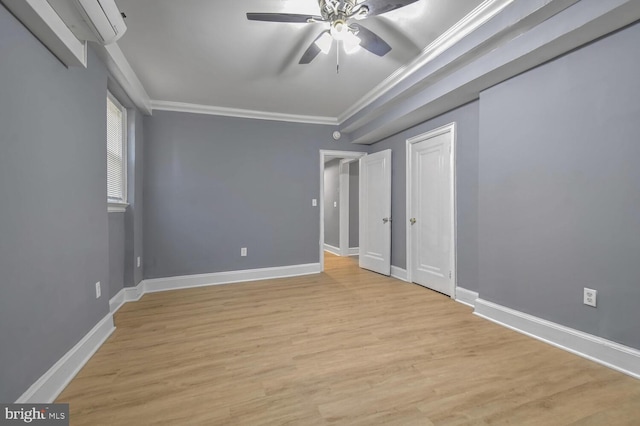 unfurnished bedroom featuring light wood-style flooring, a wall mounted AC, ornamental molding, a ceiling fan, and baseboards