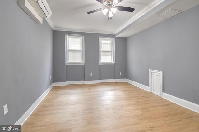 spare room with light wood-type flooring, ceiling fan, baseboards, and ornamental molding