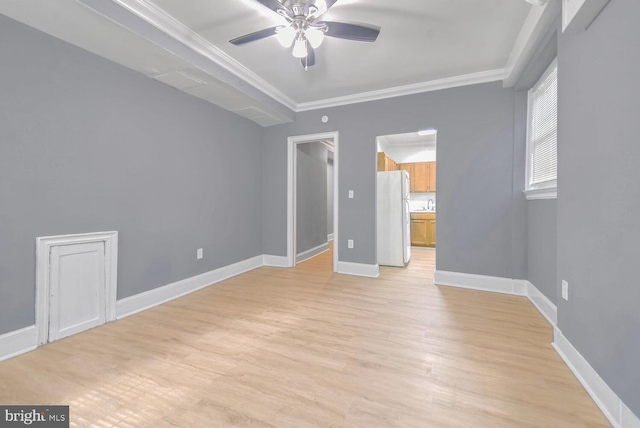 unfurnished bedroom with crown molding, ensuite bathroom, freestanding refrigerator, light wood-type flooring, and baseboards