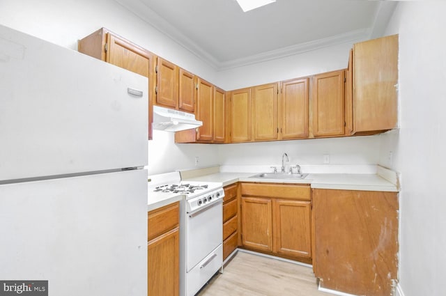 kitchen with light countertops, ornamental molding, a sink, white appliances, and under cabinet range hood