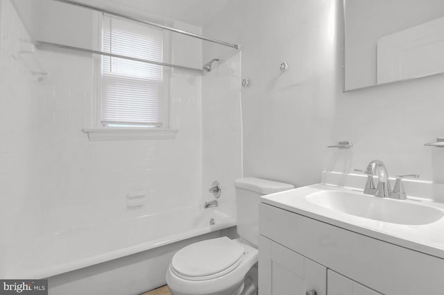 bathroom featuring  shower combination, vanity, and toilet