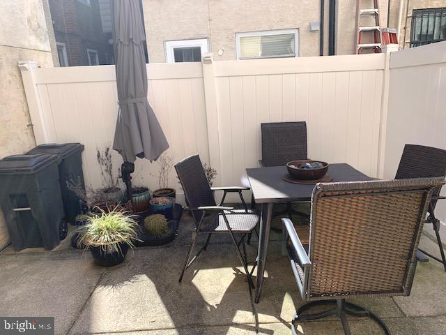 view of patio with outdoor dining area and fence