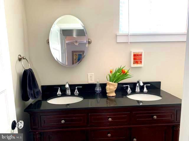 bathroom featuring double vanity and a sink