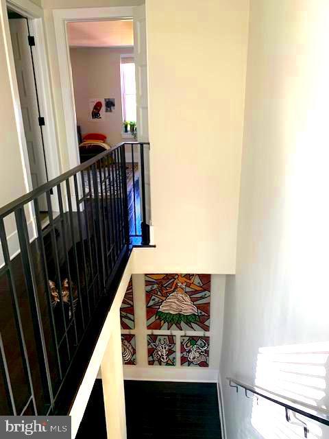 hallway featuring an upstairs landing