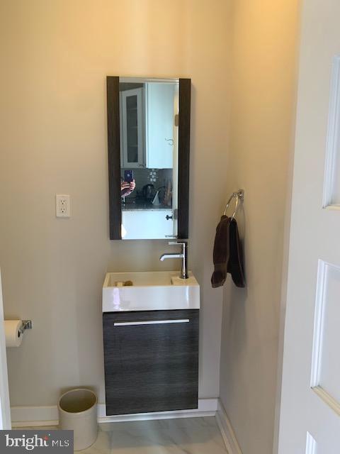 bathroom with vanity and baseboards