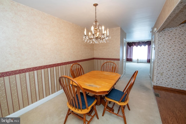 dining room with wallpapered walls, baseboards, and carpet floors