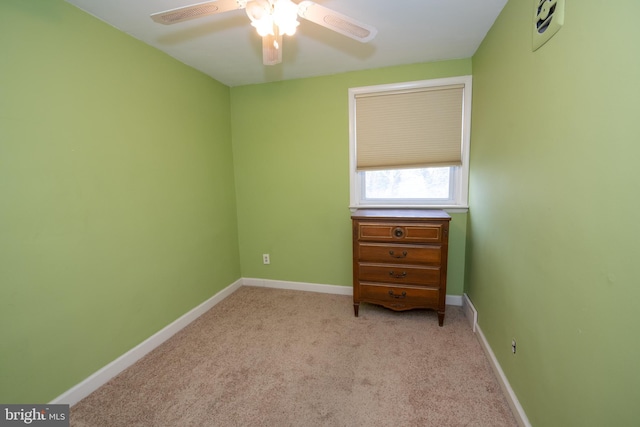 unfurnished bedroom with light carpet, ceiling fan, and baseboards