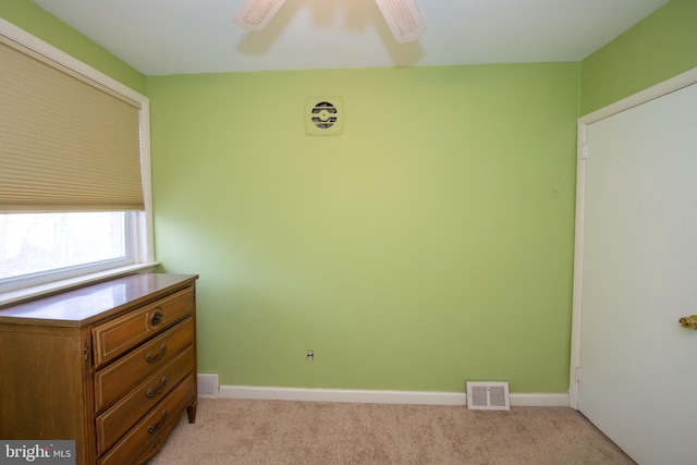 unfurnished bedroom featuring light colored carpet, visible vents, and baseboards