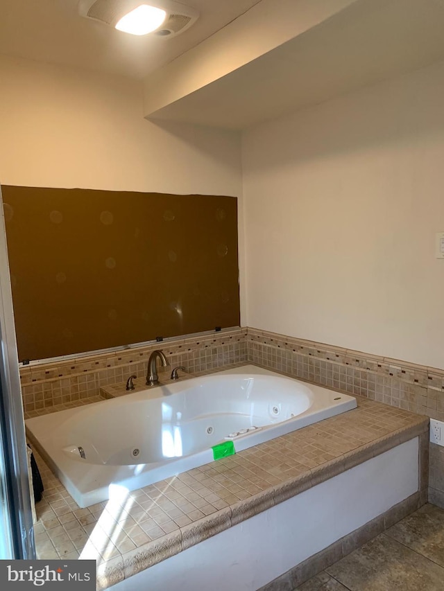 full bathroom with a tub with jets and tile patterned flooring