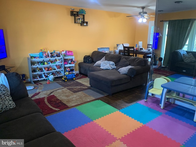 living room with ceiling fan and wood finished floors