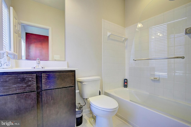 bathroom featuring baseboards, toilet, vanity, tile patterned floors, and shower / bathtub combination