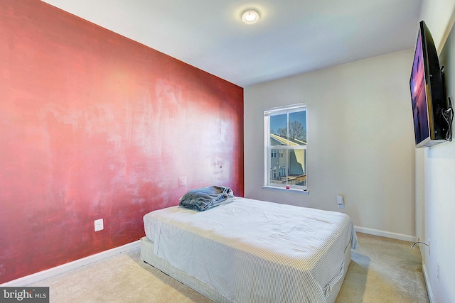 bedroom featuring carpet flooring and baseboards