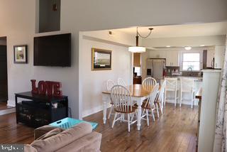 dining room with dark wood-type flooring and baseboards