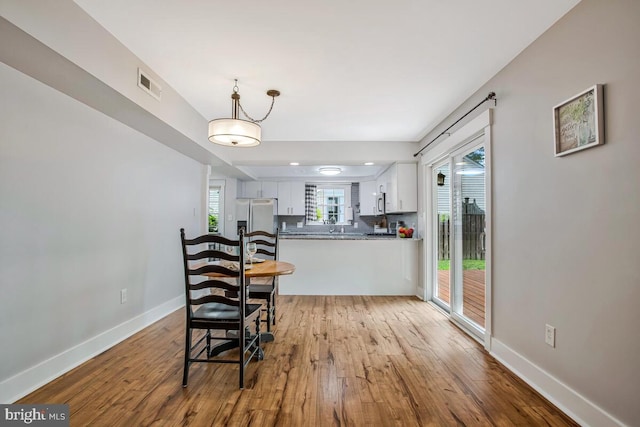 dining room with light wood-style flooring and baseboards