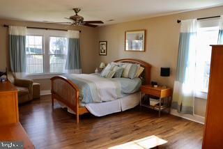 bedroom featuring wood finished floors and baseboards