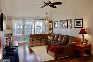living area with ceiling fan, wood finished floors, and lofted ceiling