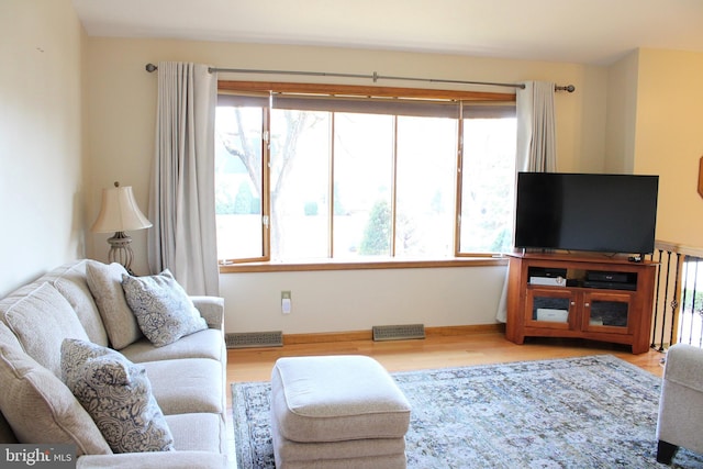 living room with visible vents and wood finished floors