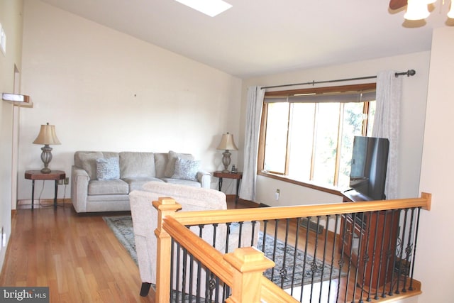 living room with lofted ceiling and wood finished floors