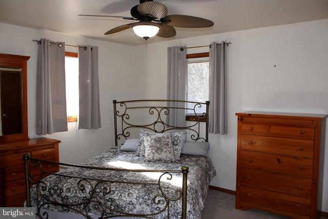 carpeted bedroom with baseboards and ceiling fan