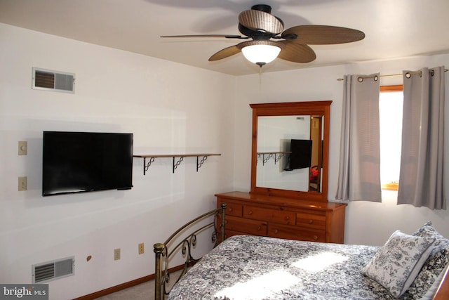 bedroom with visible vents, baseboards, and ceiling fan