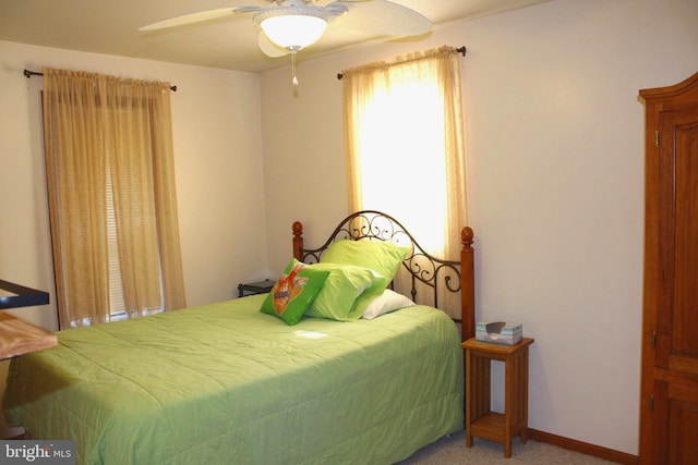 carpeted bedroom featuring a ceiling fan and baseboards