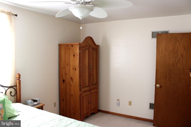 unfurnished bedroom featuring visible vents, baseboards, light colored carpet, and ceiling fan