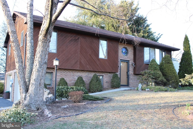 bi-level home featuring brick siding