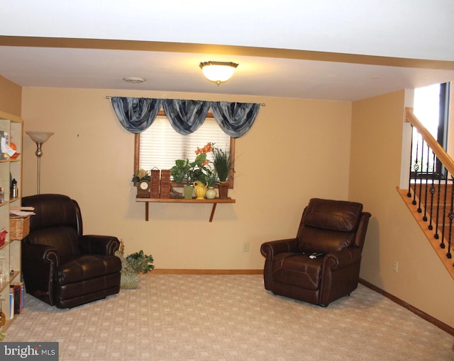 sitting room featuring carpet flooring, baseboards, and a wealth of natural light