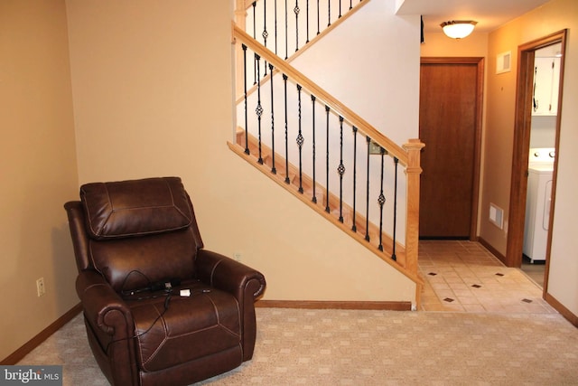 interior space featuring baseboards, washer / clothes dryer, carpet, and stairway