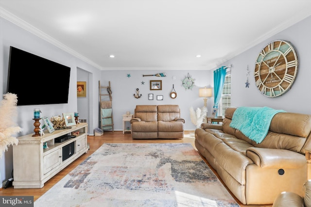 living area with recessed lighting, light wood-type flooring, and ornamental molding