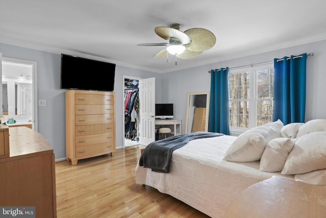 bedroom with light wood finished floors, crown molding, baseboards, a closet, and a ceiling fan