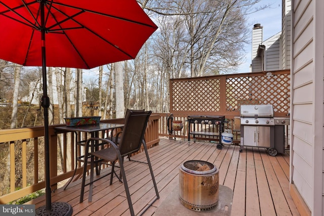 wooden deck with a grill